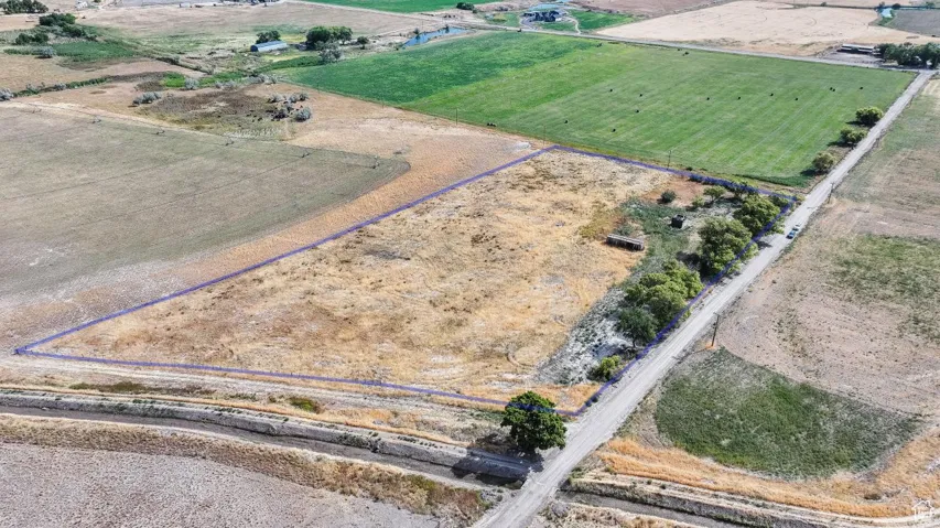 Aerial view of property and surrounding area featuring rural landscape and property boundaries highlighted