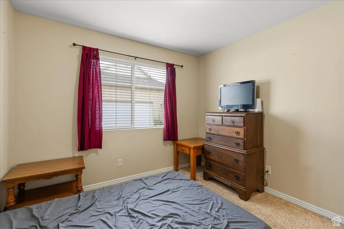 Carpeted bedroom with baseboards
