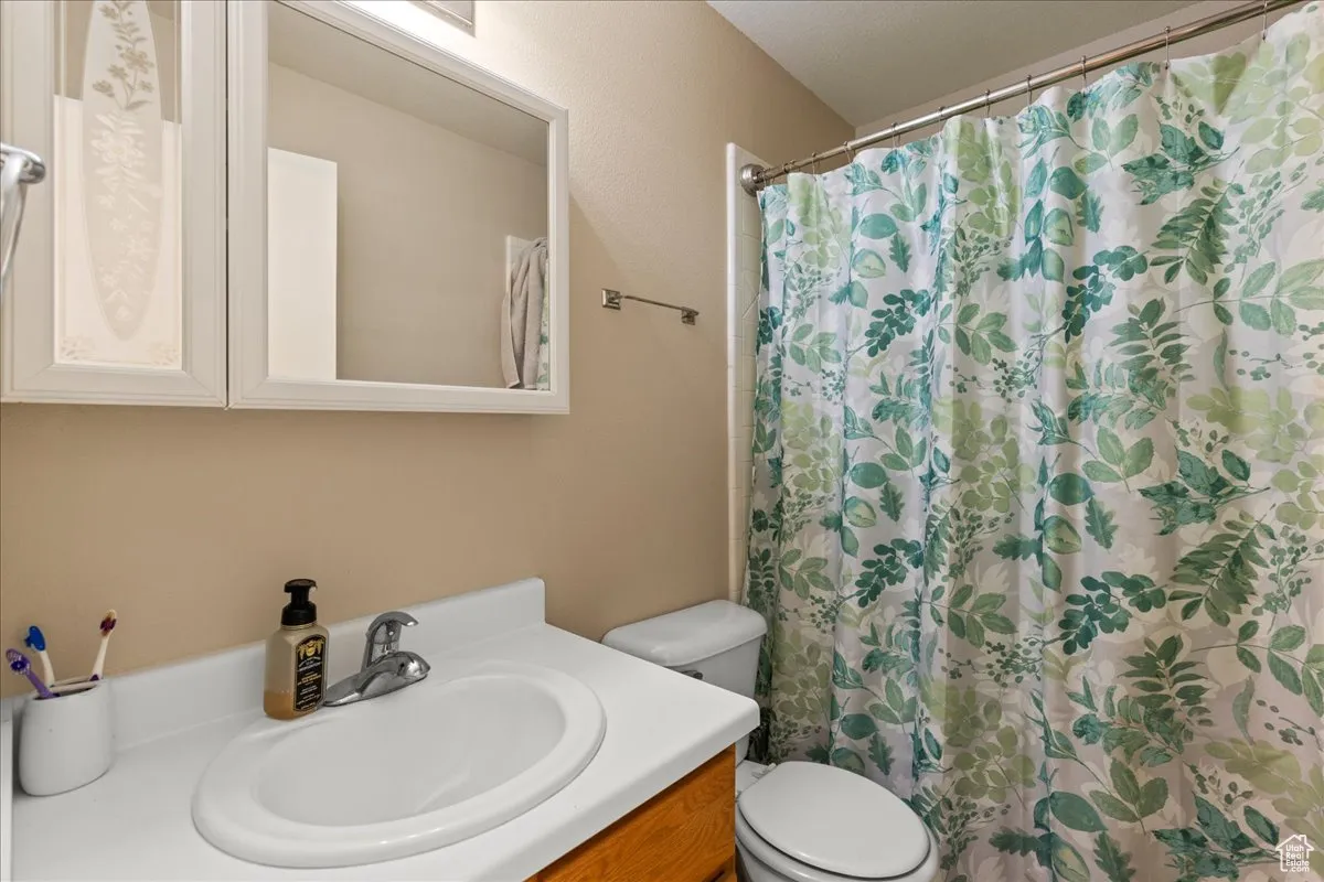 Full bathroom featuring vanity and curtained shower