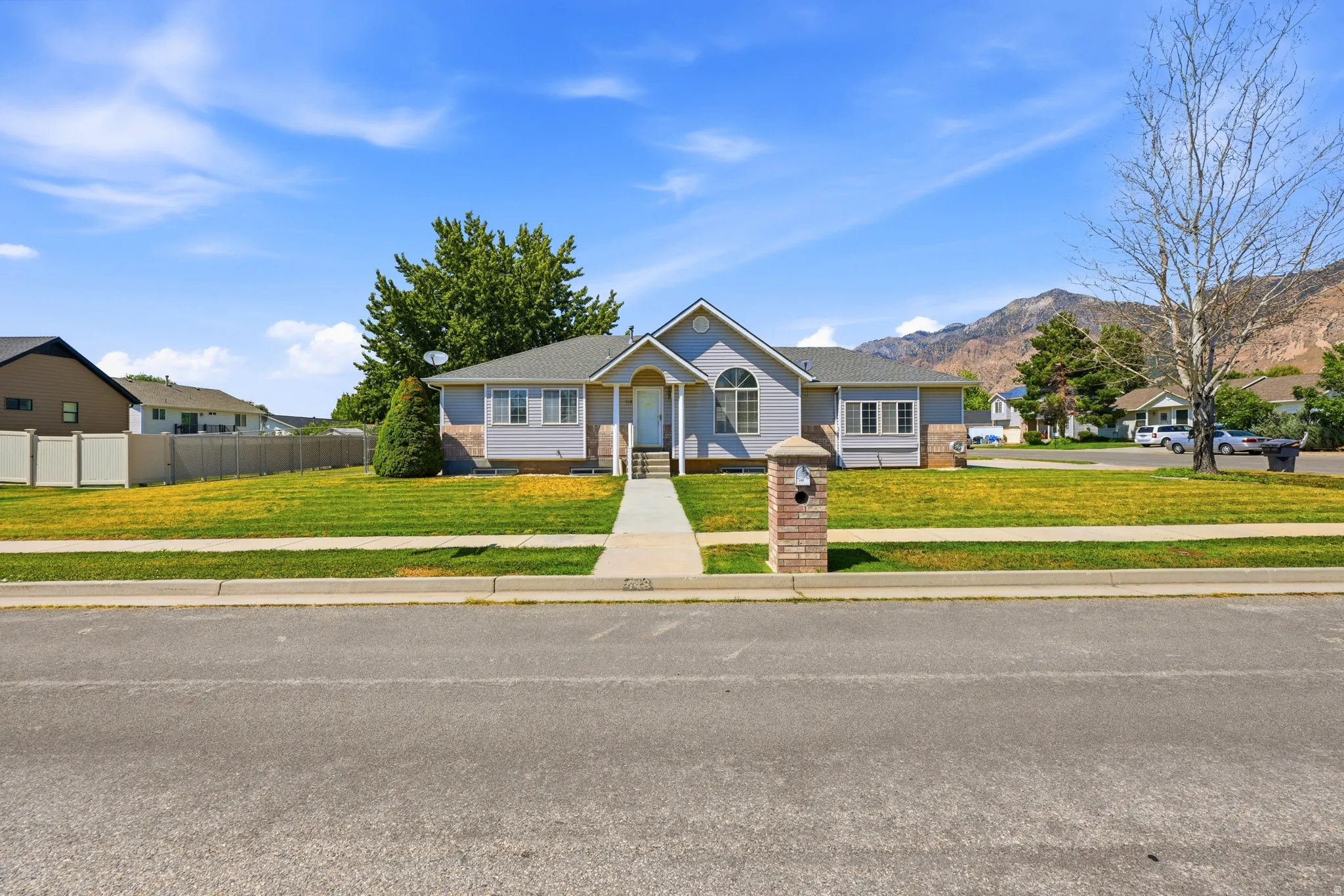 Ranch-style exterior with light blue siding and white trim