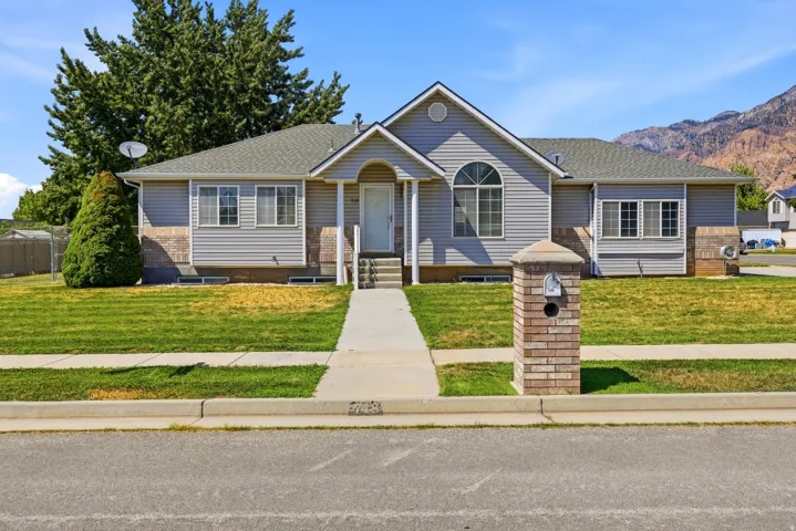 Ranch-style exterior with gray horizontal siding and a brick facade accent