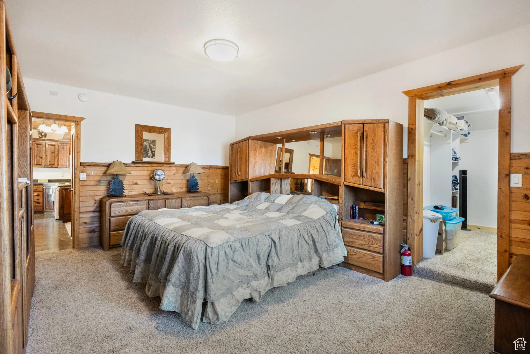 Carpeted bedroom with wood walls
