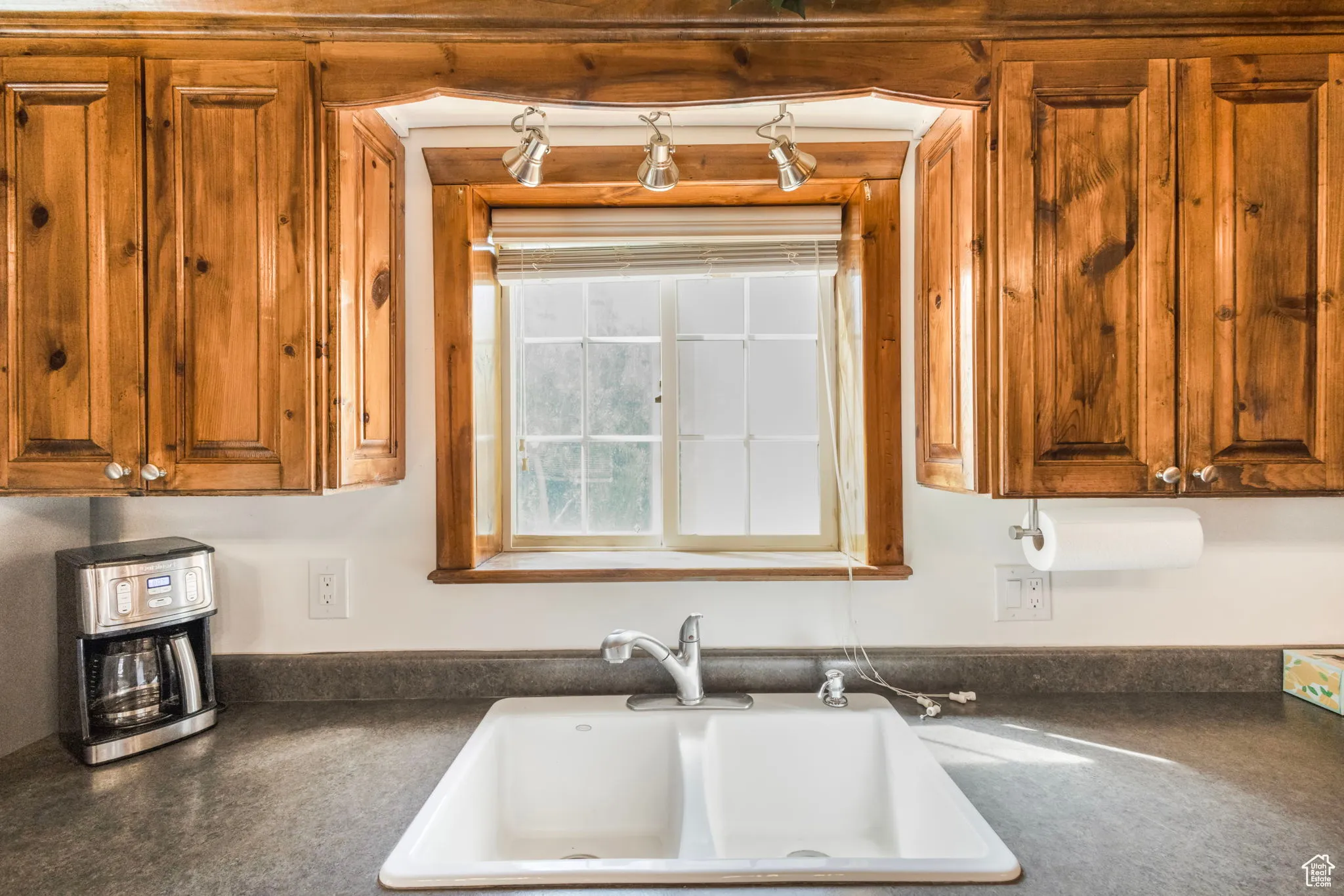 Kitchen featuring dark countertops and brown cabinetry