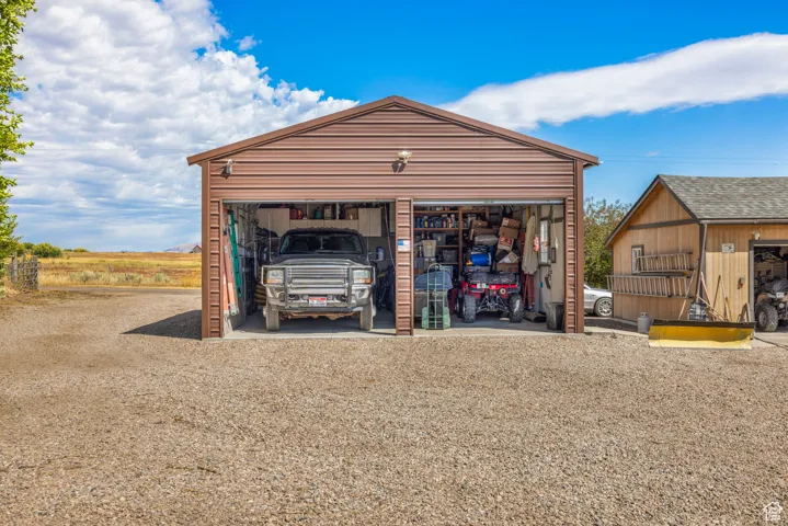 View of outdoor structure with gravel driveway