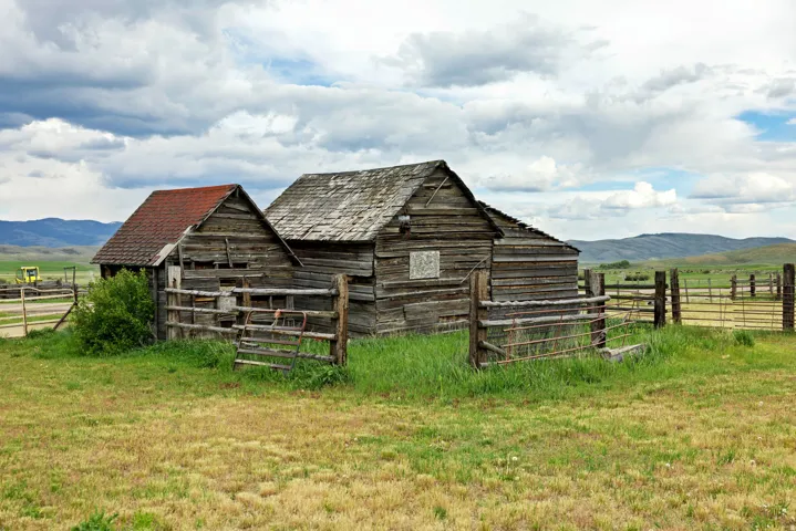 Rustic timber outbuildings featuring weathered wood siding and pitched roofs