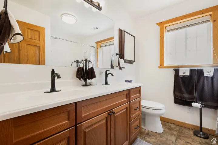 Bathroom featuring double vanity and curtained shower