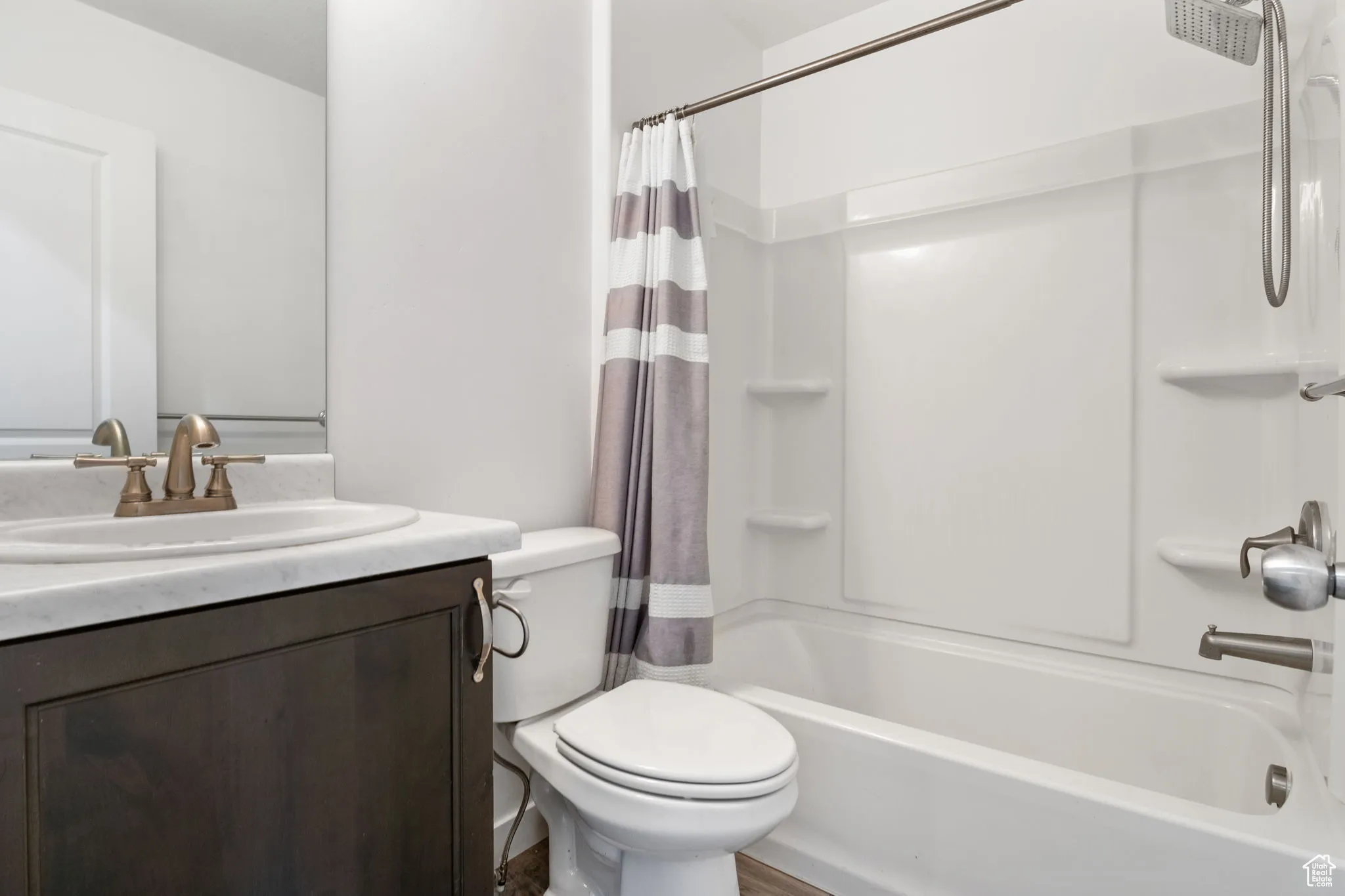 Bathroom with shower / tub combo and vanity