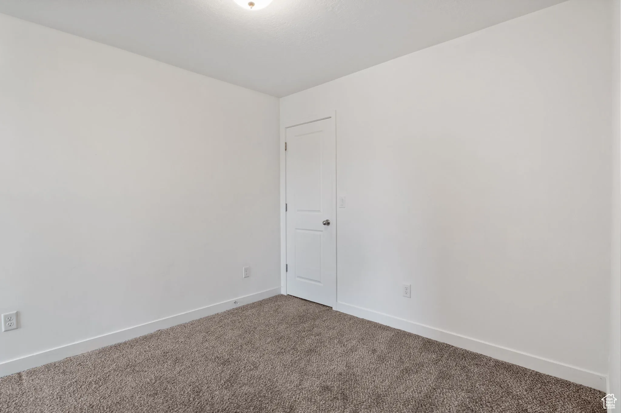 Spare room with carpet floors and baseboards