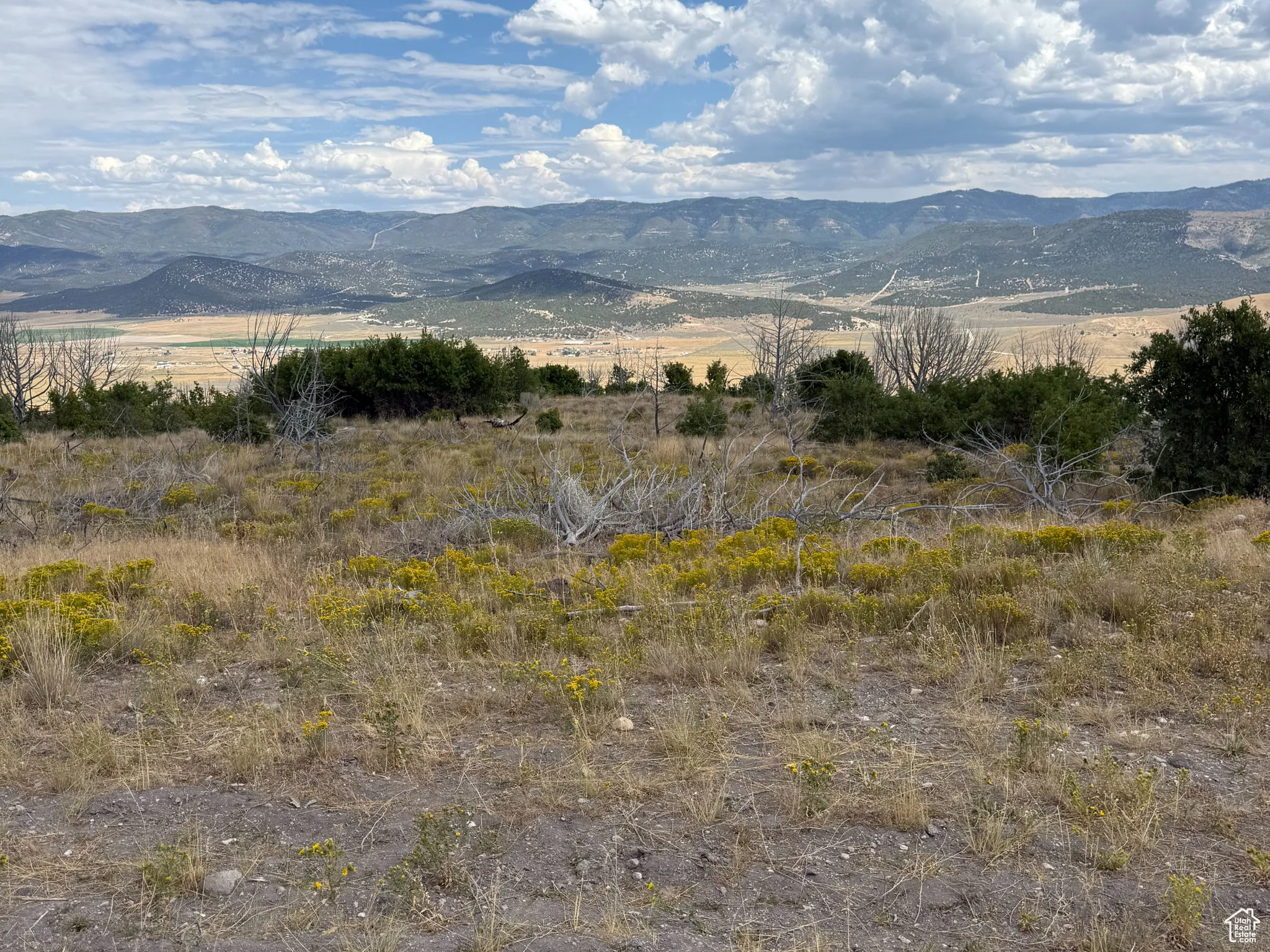 View of mountain backdrop featuring rural landscape