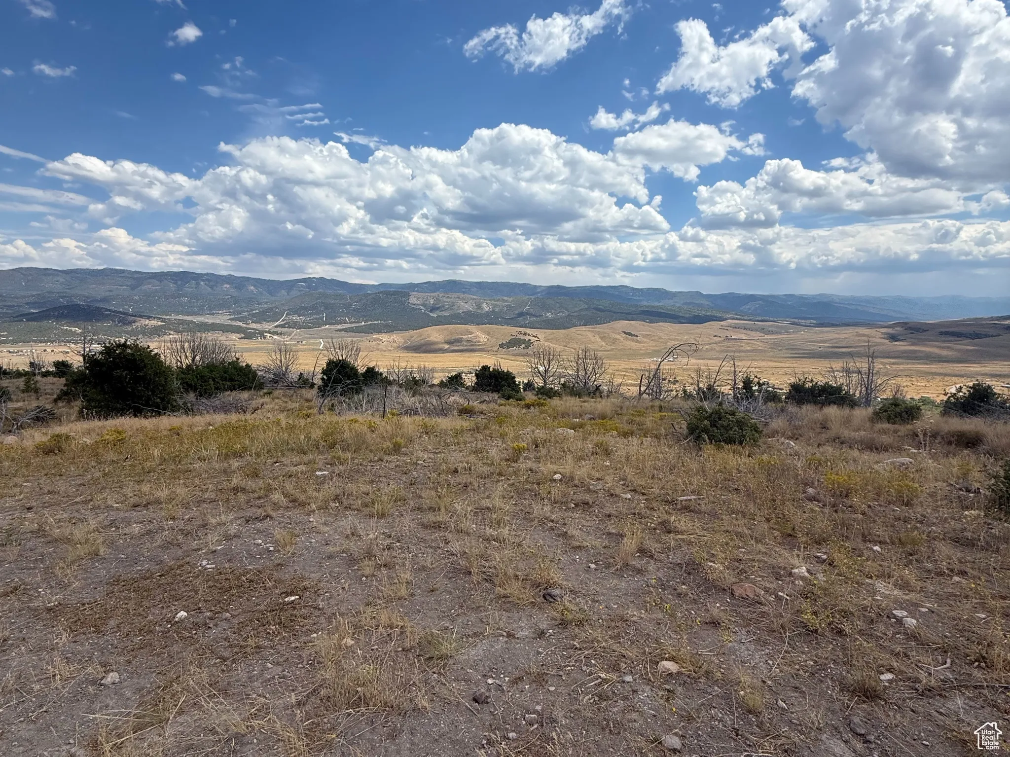 View of mountain backdrop featuring rural landscape