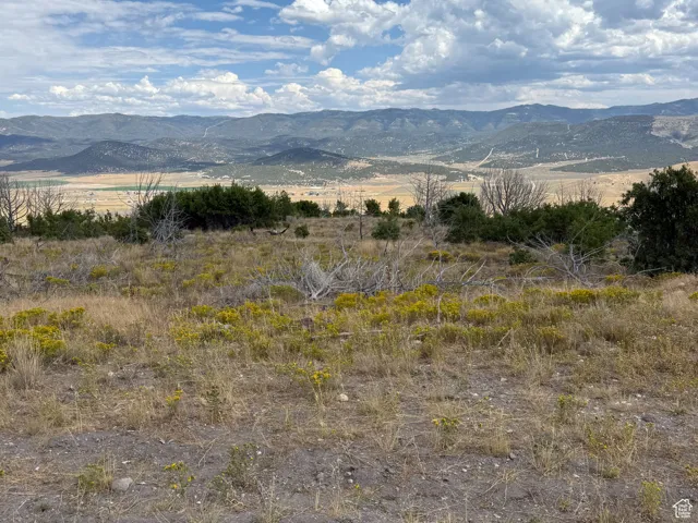 View of mountain backdrop featuring rural landscape