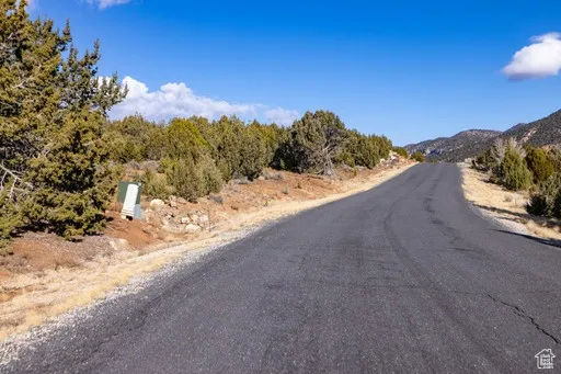 View of asphalt street featuring a mountain view