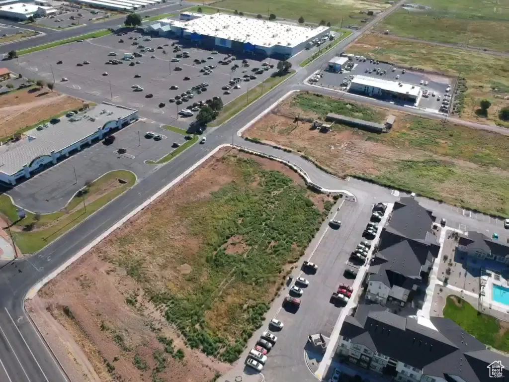 Aerial view of property looking northeast. Main street lower left corner, large apartment complex on right, Walmart upper center.