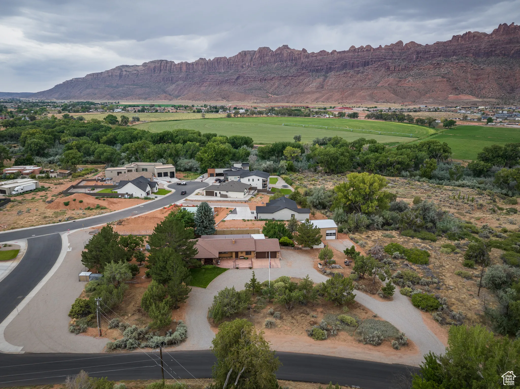 Aerial view of property's location featuring a mountain backdrop and nearby suburban area
