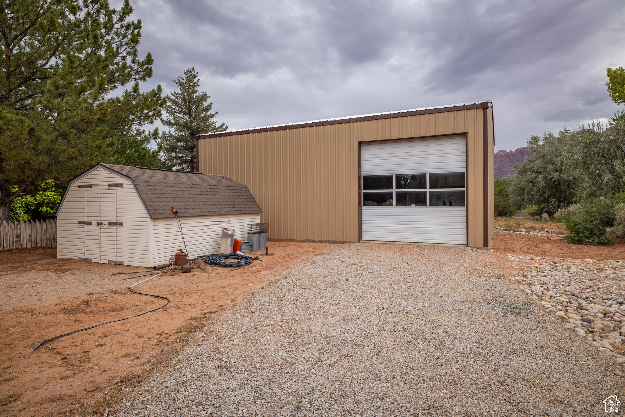 Detached garage with gravel driveway