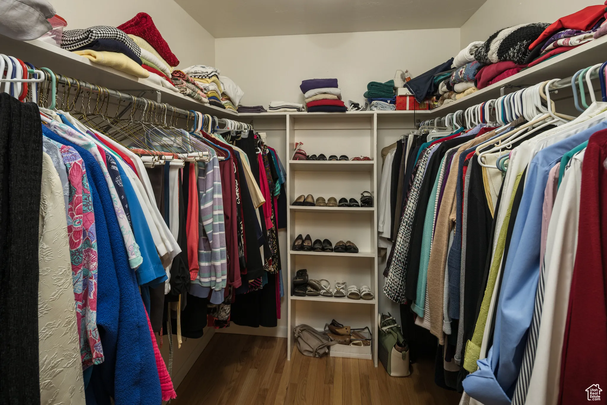 Walk in closet featuring dark wood finished floors