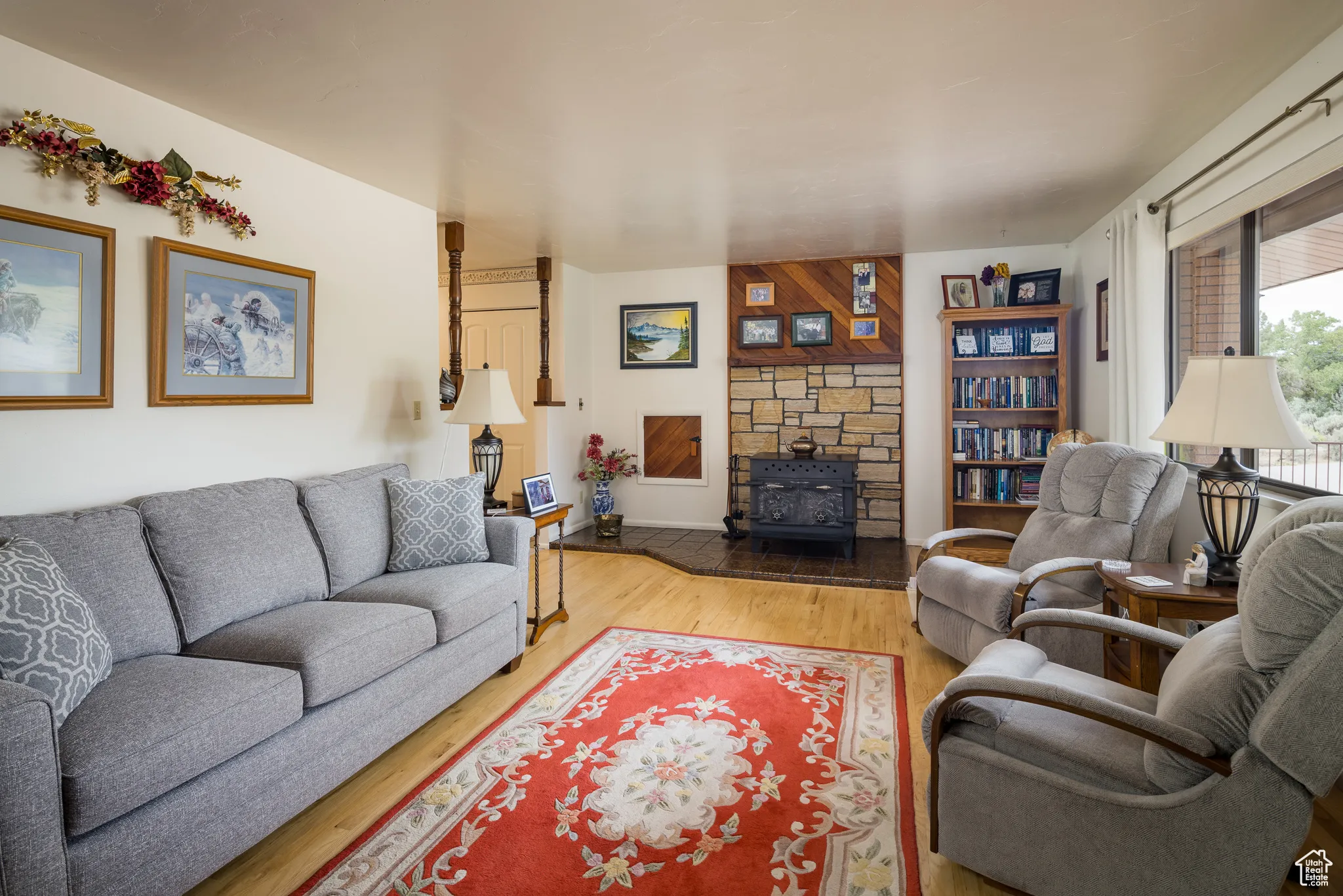 Living room featuring light wood-style flooring and a wood stove