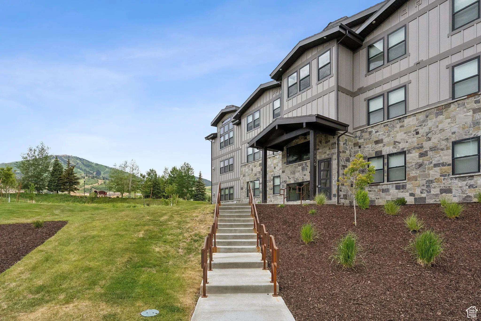 View of building exterior with a mountain view and stairway