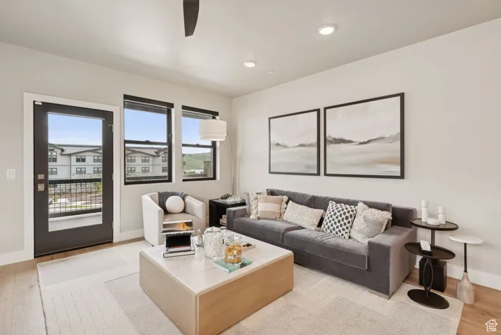 Living area with light wood finished floors, recessed lighting, and ceiling fan