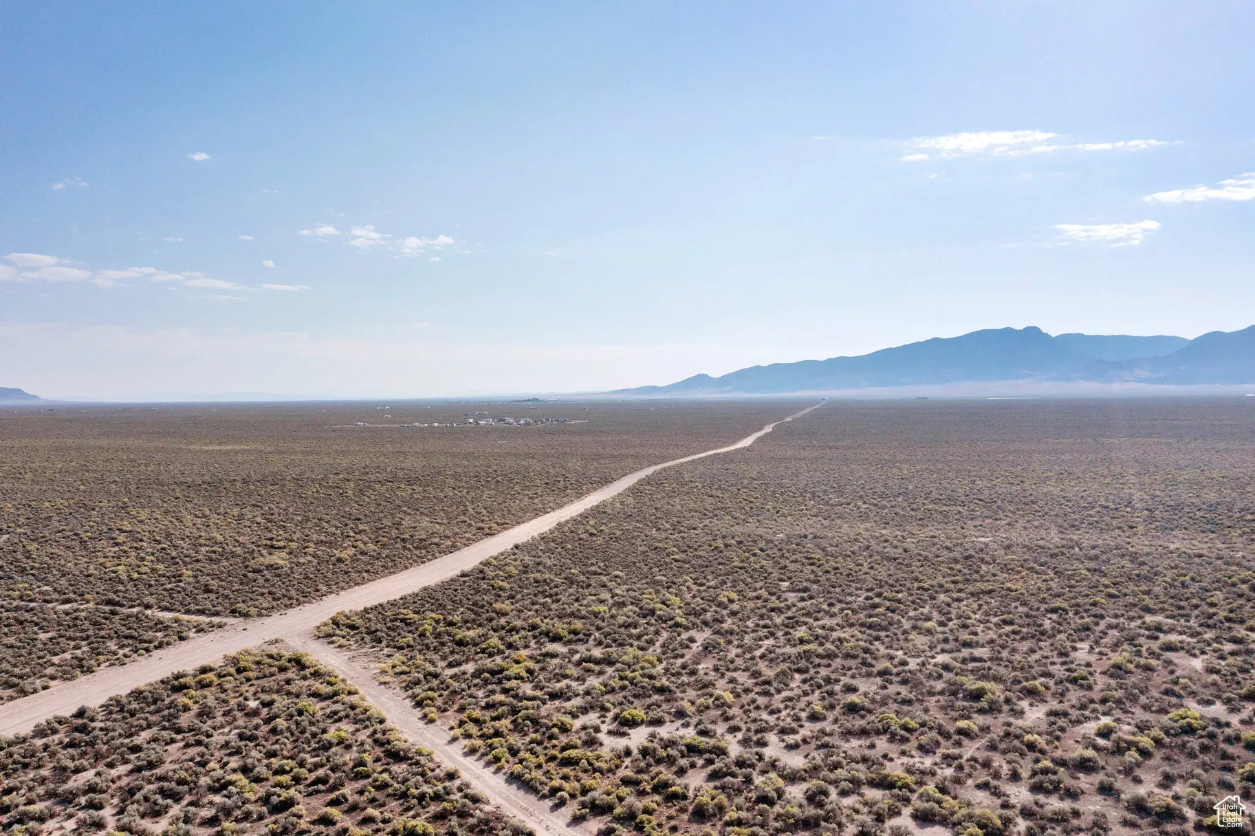 Overview of rural landscape featuring a mountainous background and a desert landscape