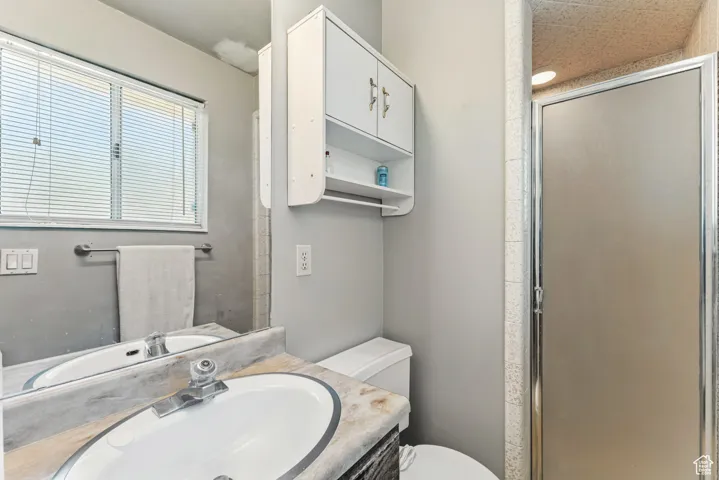 Bathroom with vanity and a shower stall