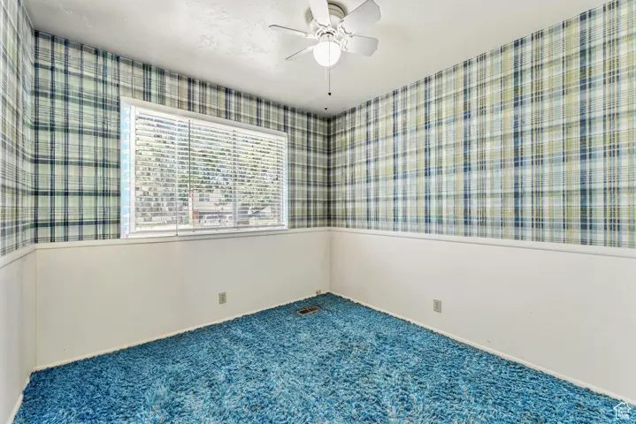 Carpeted spare room with baseboards