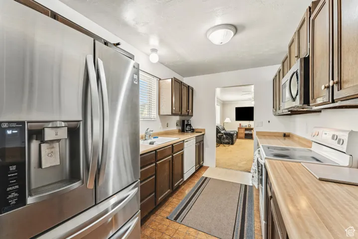 Kitchen featuring stainless steel appliances and dark brown cabinetry