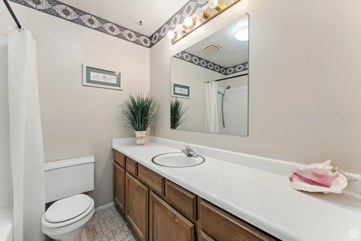 Full bathroom featuring vanity and shower / bathtub combination with curtain
