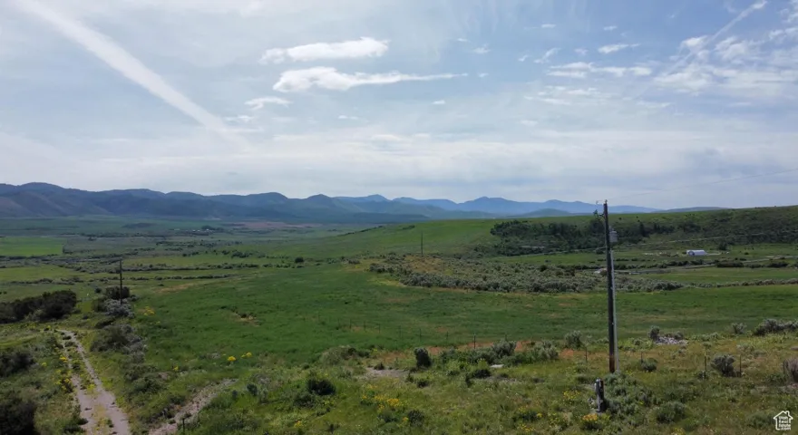 View of mountain backdrop with rural landscape