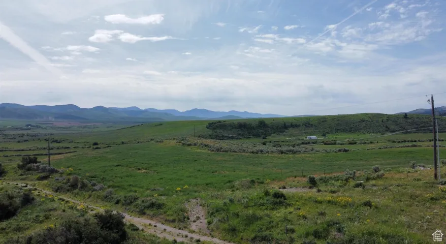 View of mountain backdrop featuring rural landscape