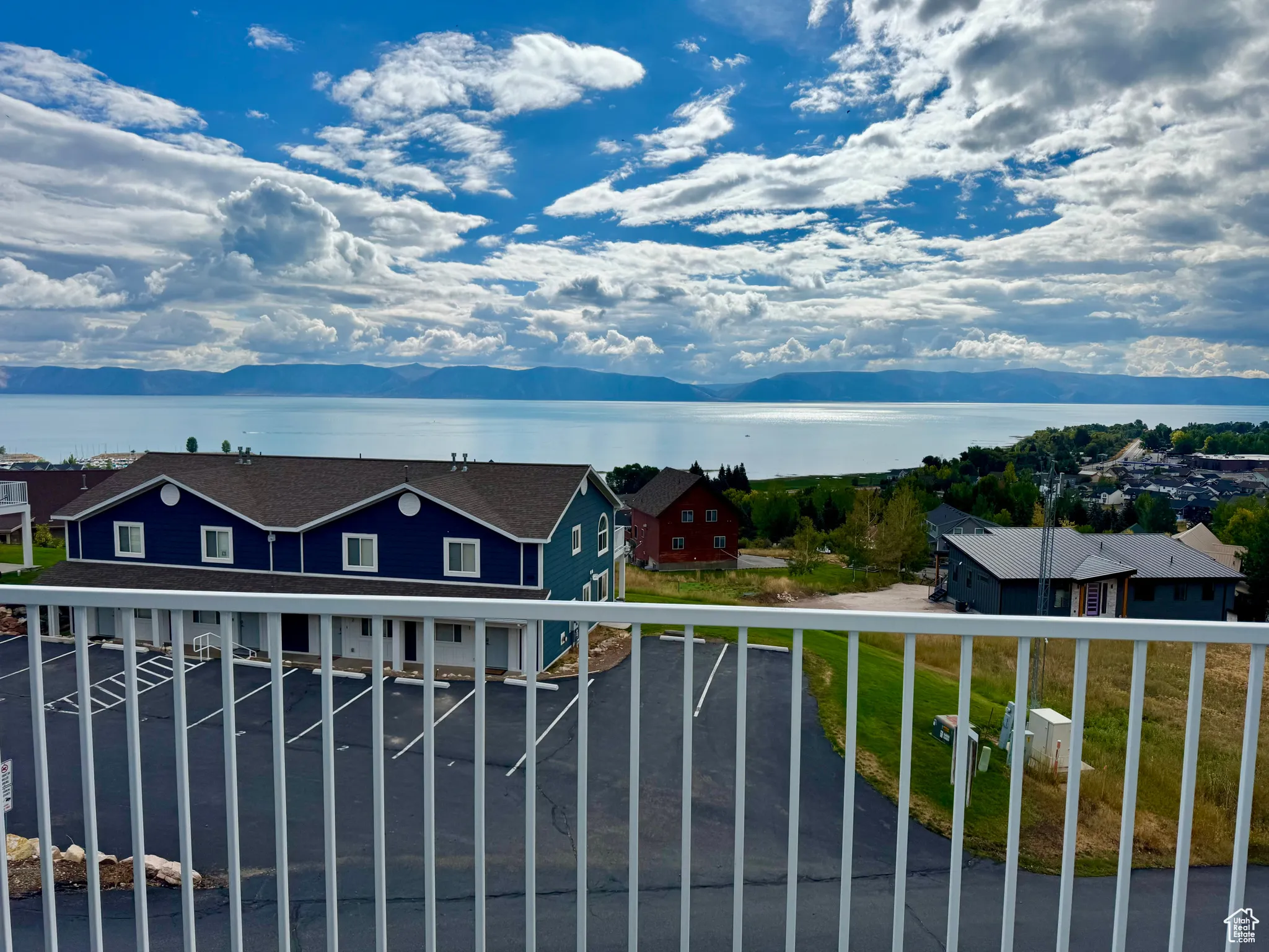 Balcony featuring a water and mountain view
