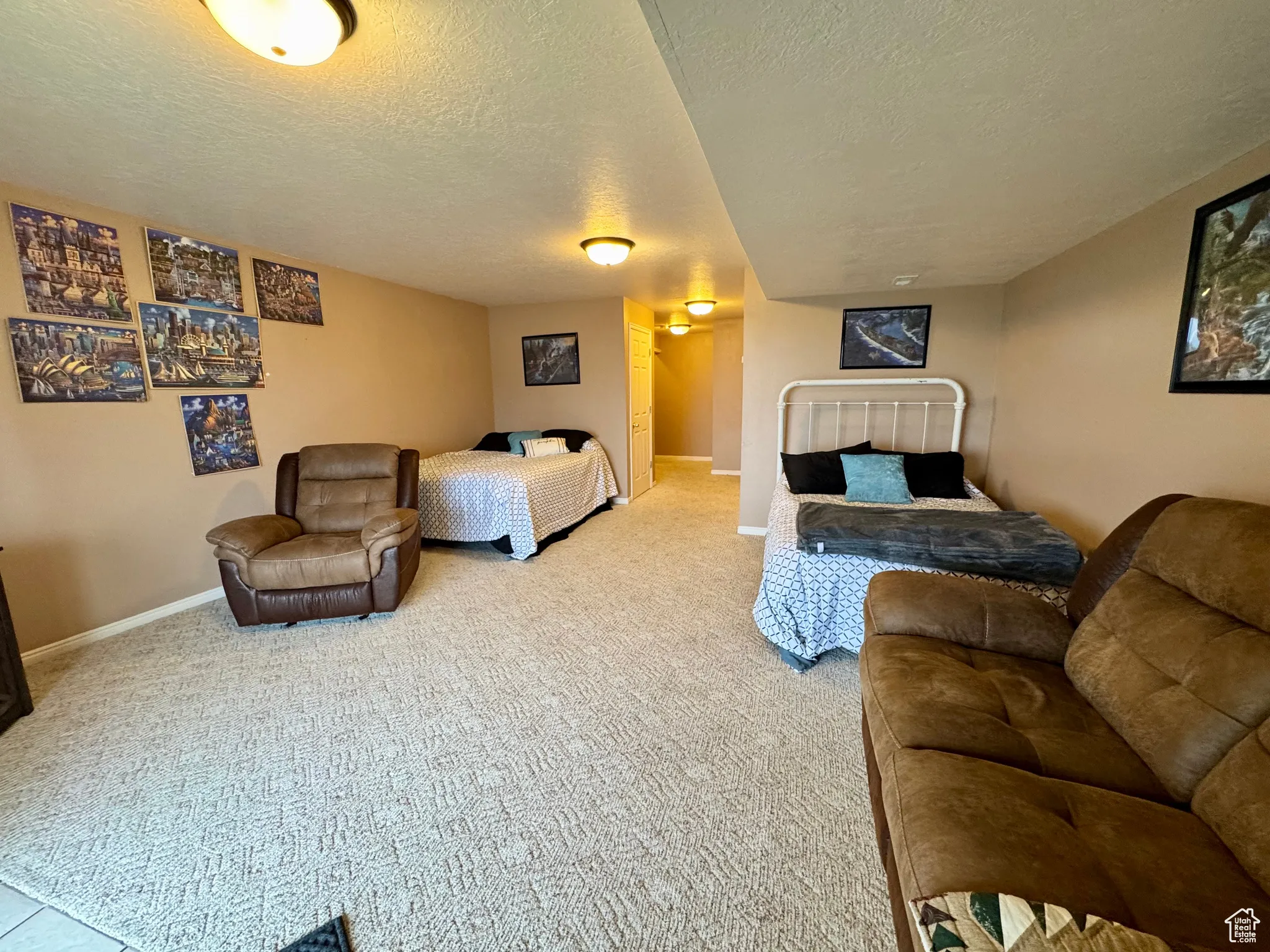 Bedroom with a textured ceiling and carpet flooring