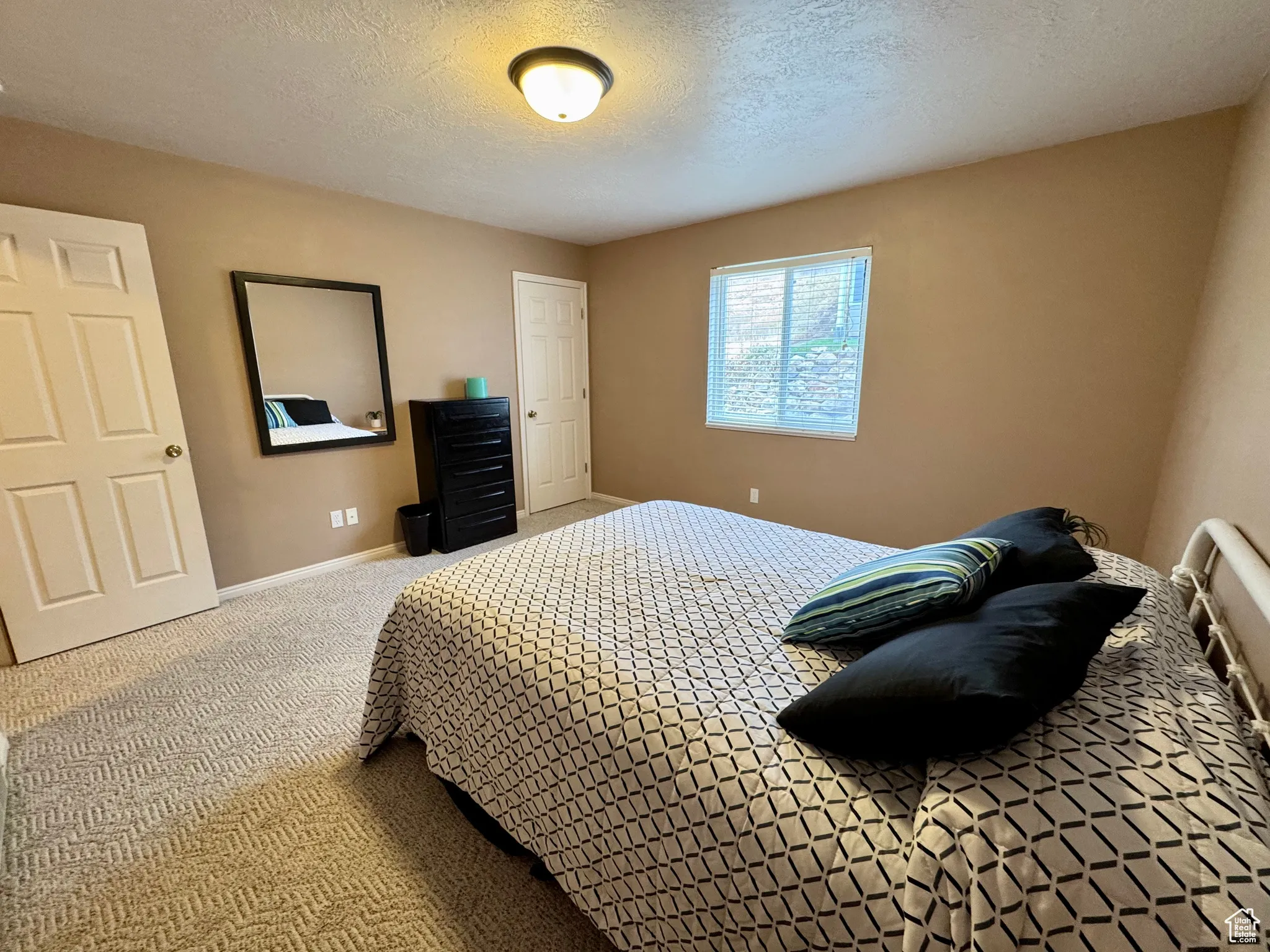 Bedroom with carpet and a textured ceiling