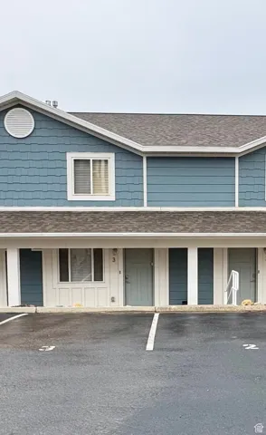 View of front of property with a shingled roof and board and batten siding