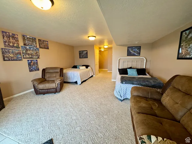 Bedroom with a textured ceiling and carpet flooring