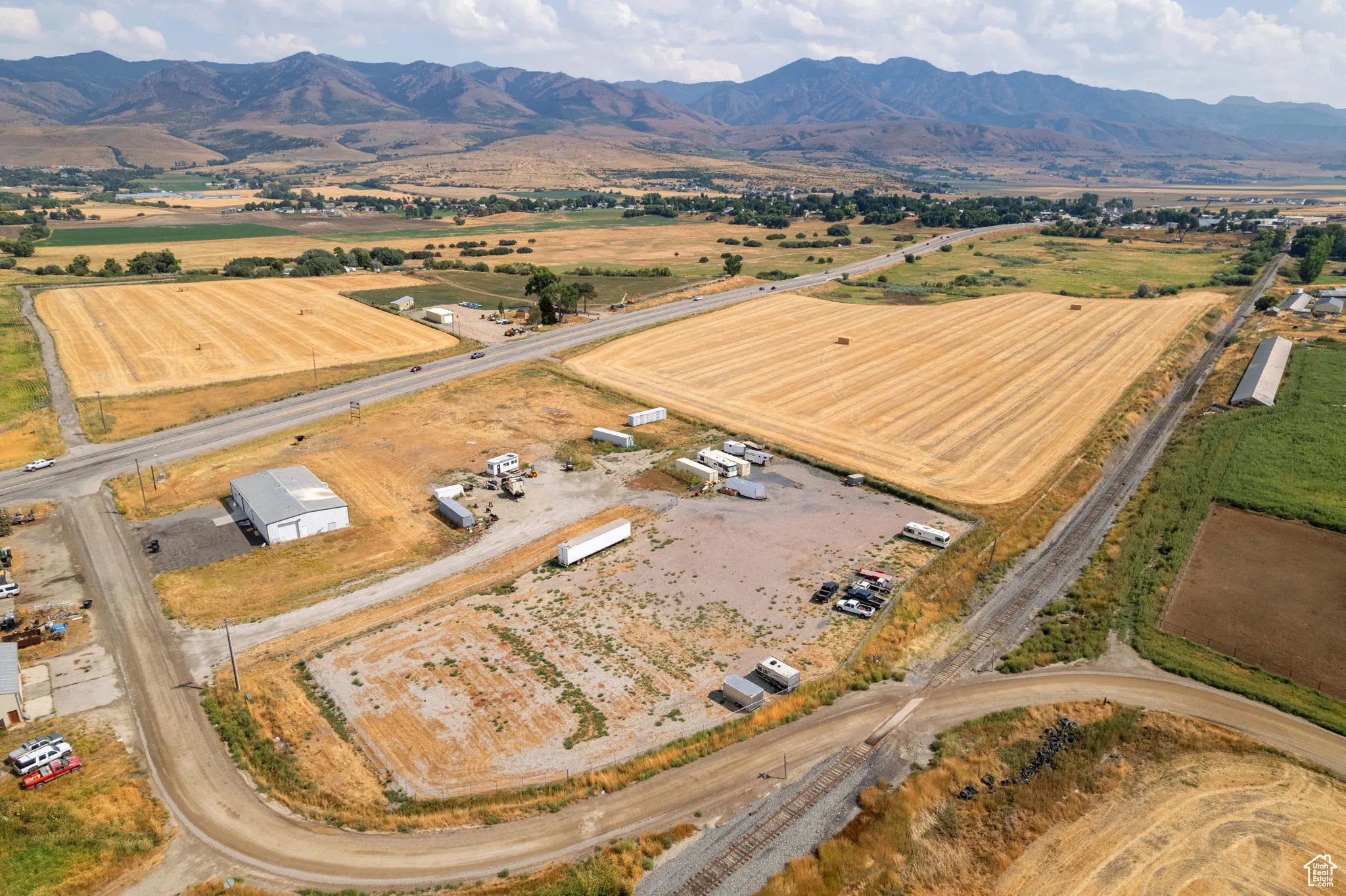 Aerial view of property and surrounding area featuring mountains and rural landscape