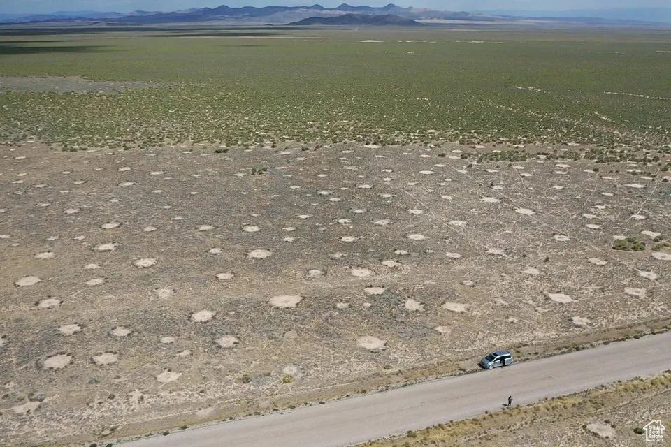 Aerial overview of property's location featuring a mountain backdrop