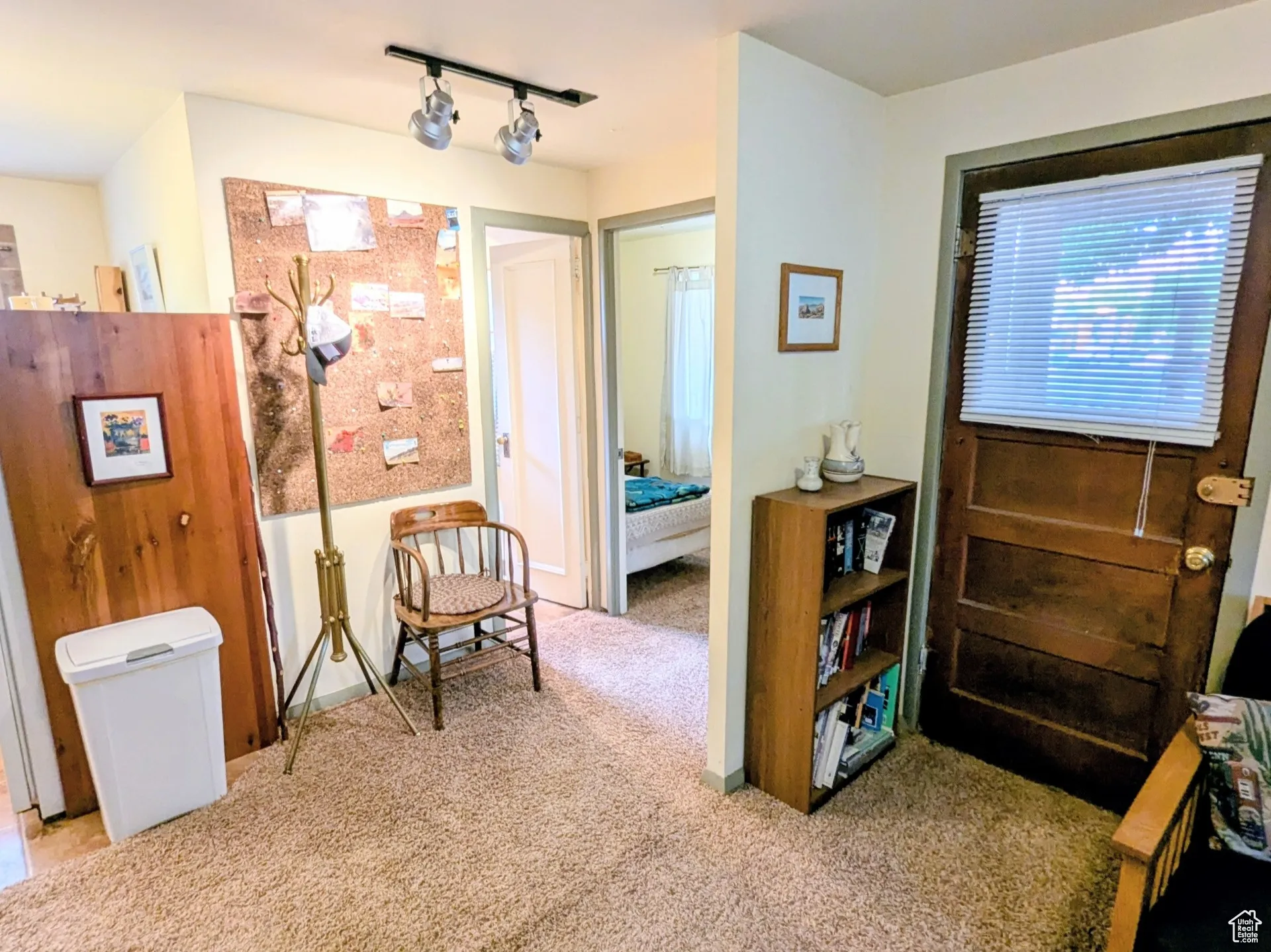 Sitting room with carpet floors and track lighting