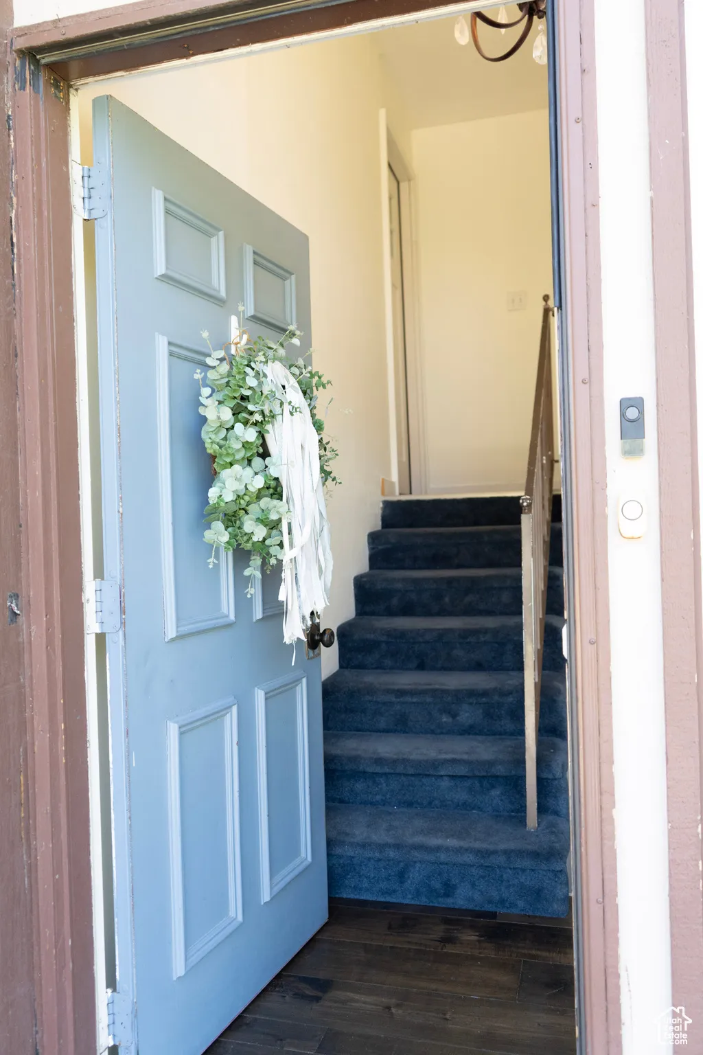 Staircase featuring wood finished floors