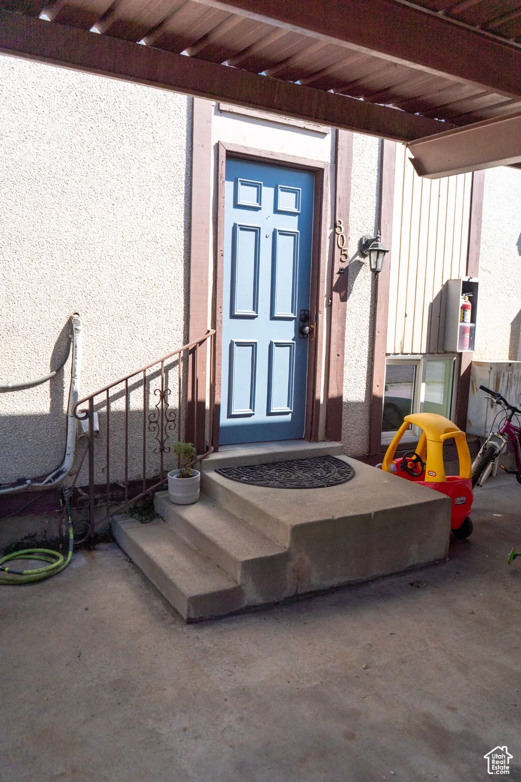 Entrance to property featuring stucco siding