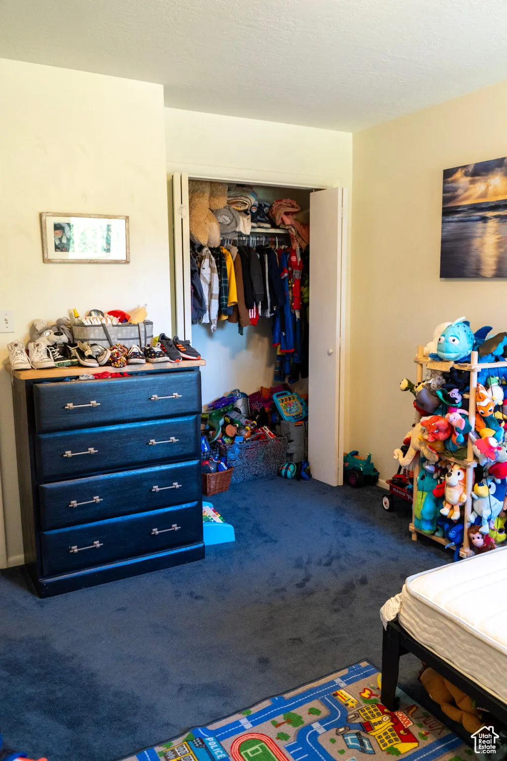 Carpeted bedroom with a closet
