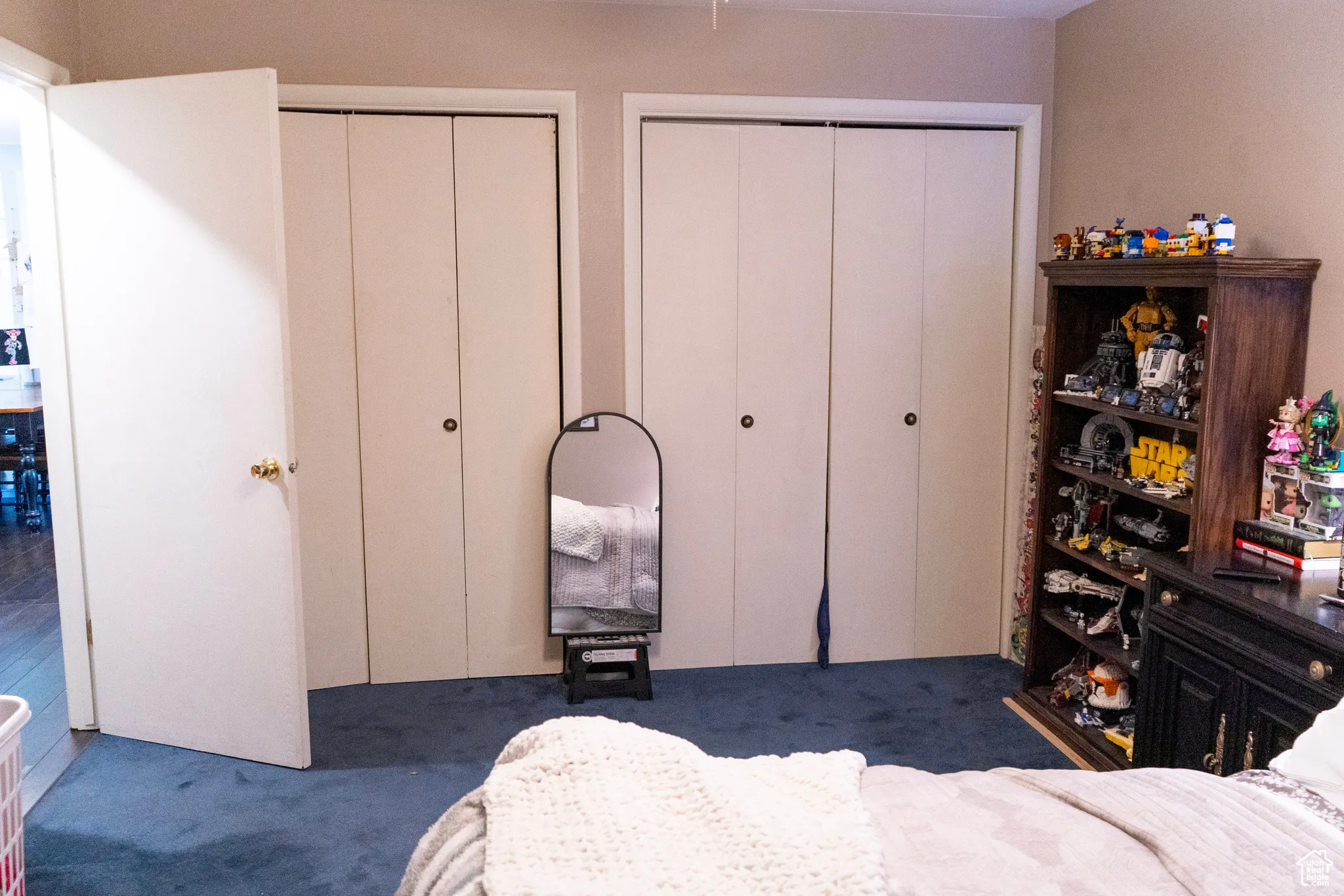Carpeted bedroom featuring two closets