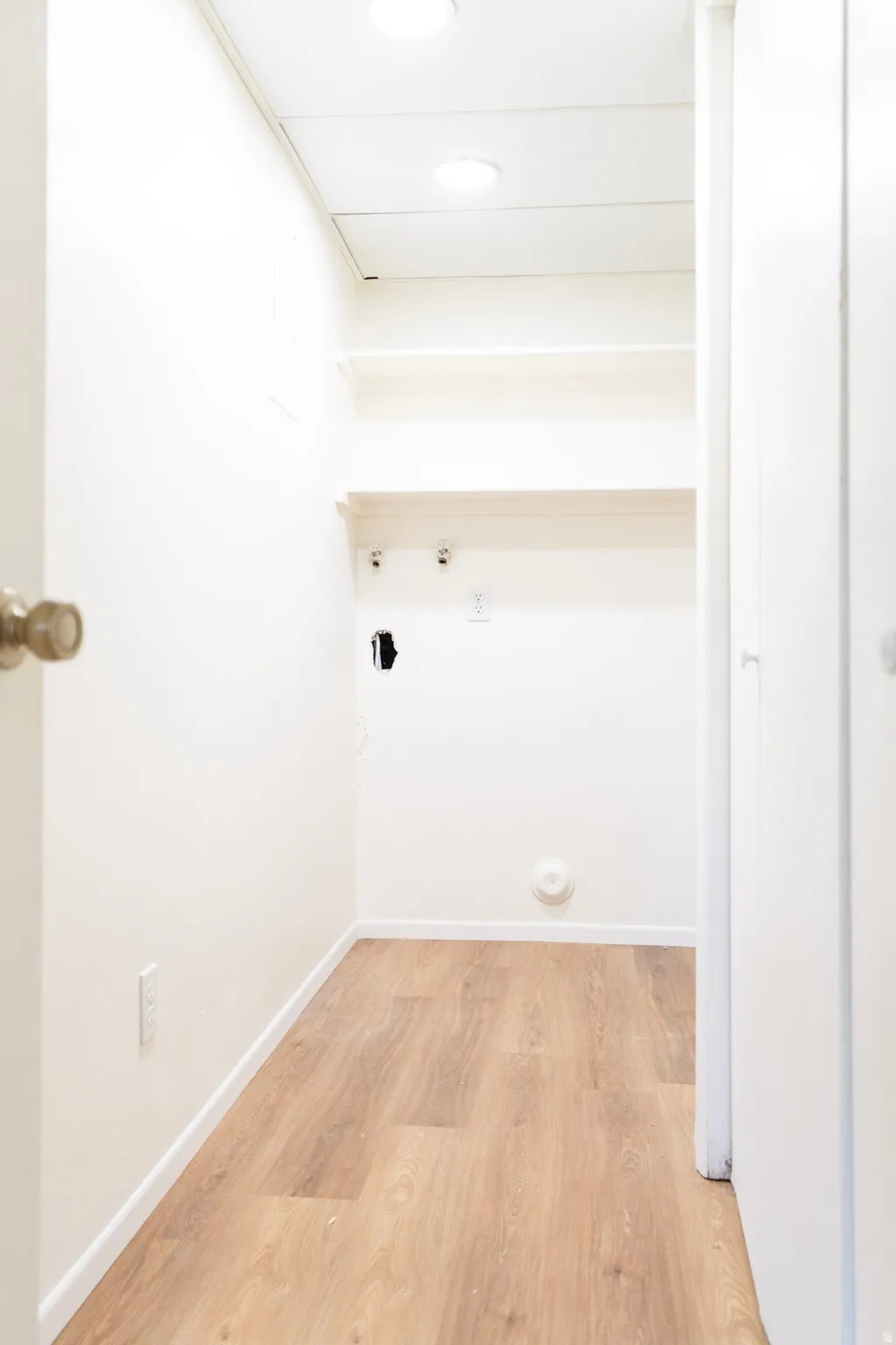 Laundry room with light wood-style flooring, gas dryer hookup, and hookup for a washing machine