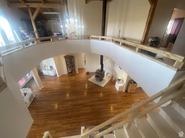 Stairs with wood finished floors and a high ceiling