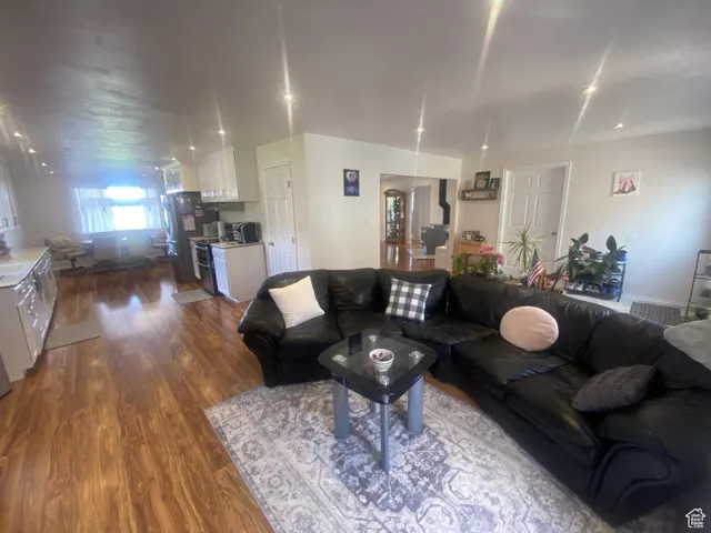 Living room with dark wood-type flooring