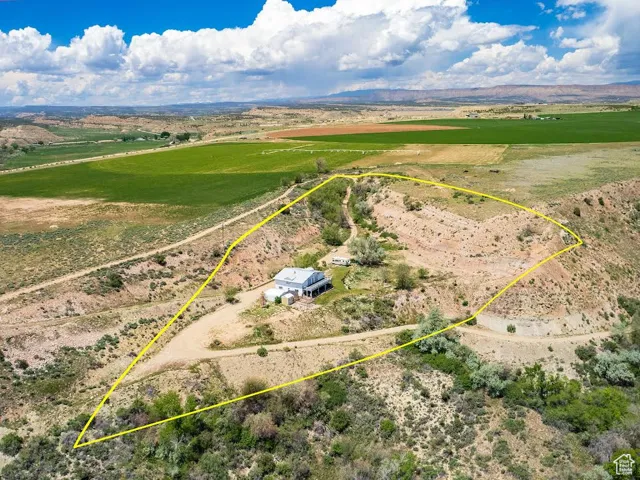 Aerial view of sparsely populated area featuring property parcel outlined