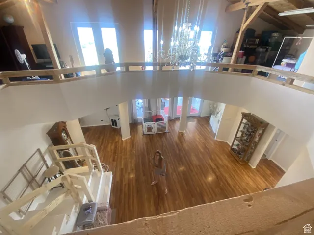 Living room with wood finished floors, a high ceiling, and plenty of natural light
