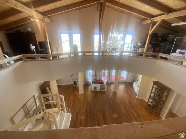 Kitchen with dark wood-style floors, high vaulted ceiling, and a wood ceiling with exposed beams