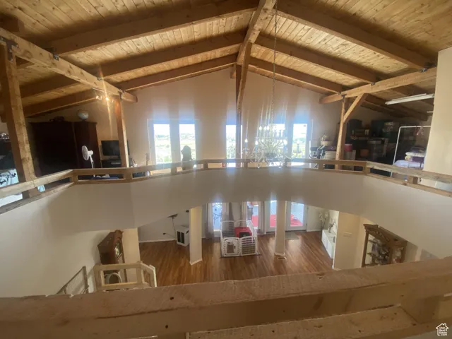 Kitchen featuring wood finished floors, high vaulted ceiling, plenty of natural light, and a wood ceiling with exposed beams