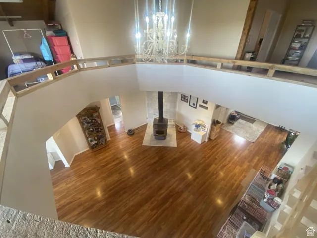 Unfurnished living room with a high ceiling and wood finished floors